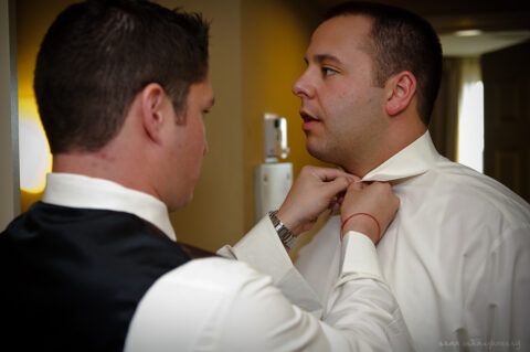 Best Man Duties include the best man helping the groom get dressed before the wedding. 