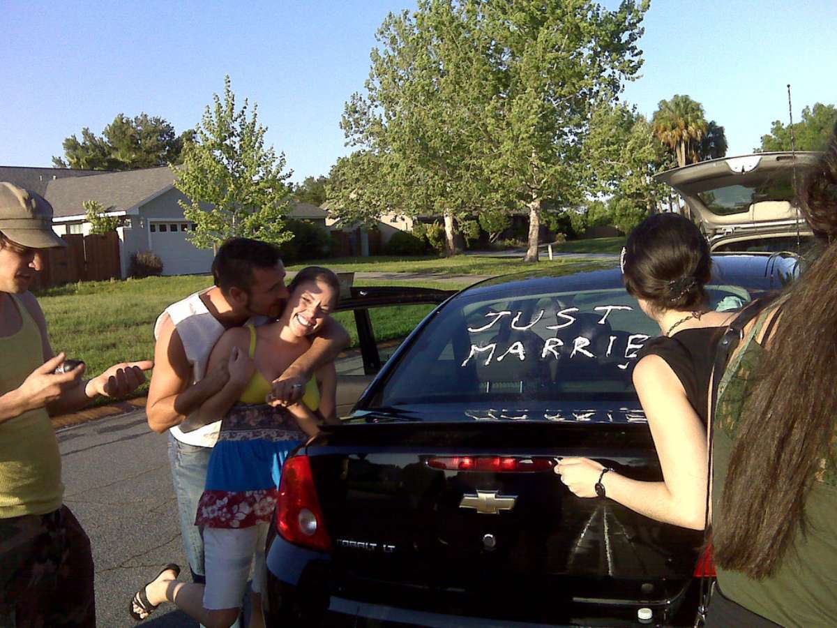 bride-groom-couple-wedding-car-by-cybergrl The bride and groom surprised to see the wedding car is being decorated.