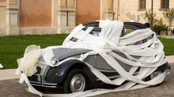 wedding-car-wrapped-in-toilet-paper-by-ScriS Toilet paper makes great wedding car decorations.